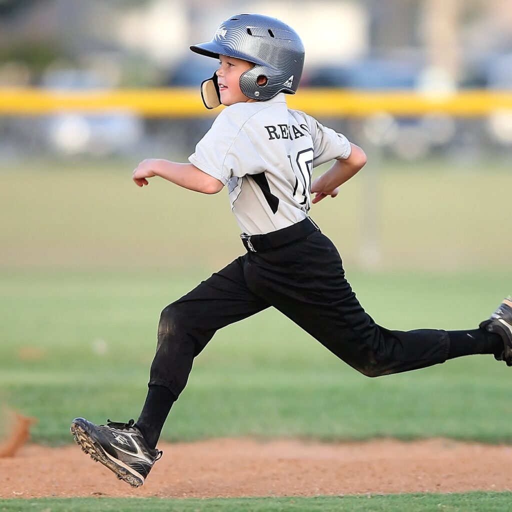 baseball player in gray and black uniform running