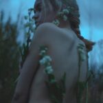 woman surrounded by flowers