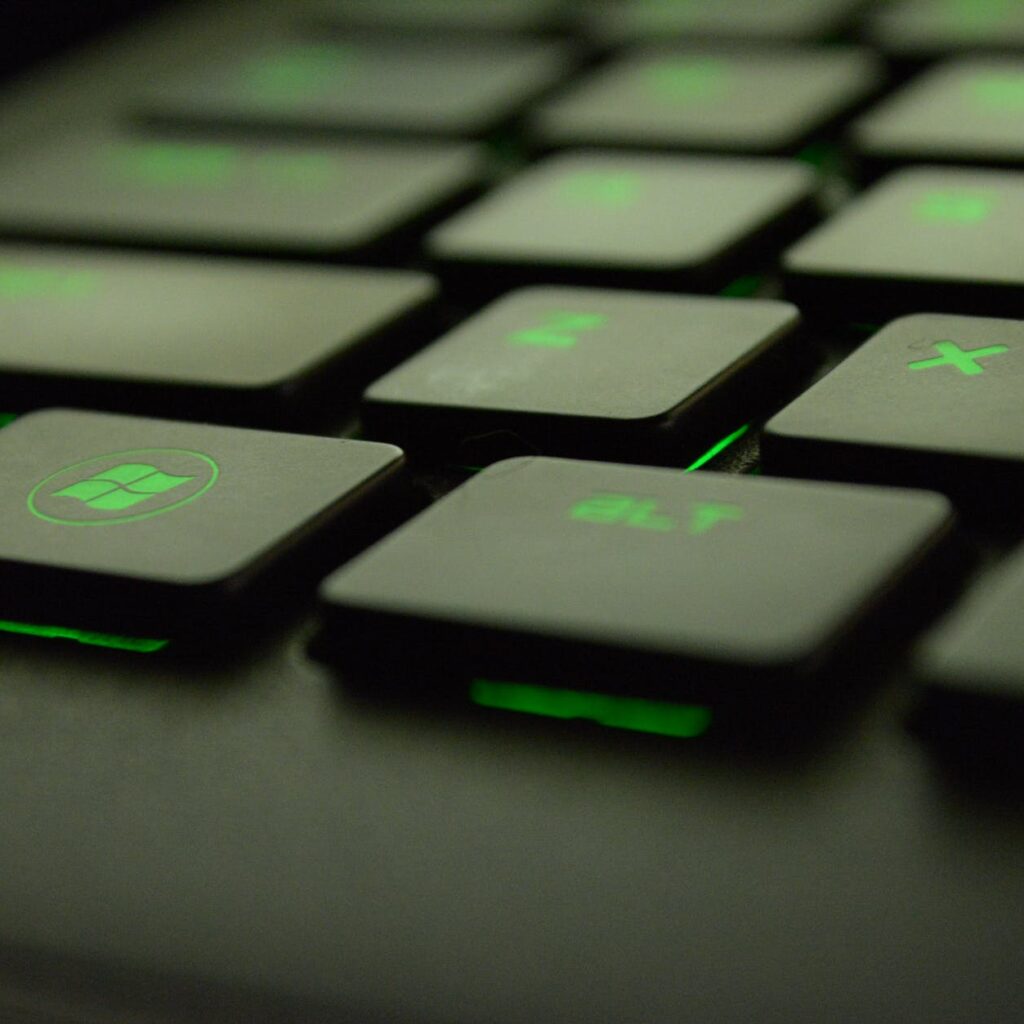close up photography of black and green computer keyboard keys