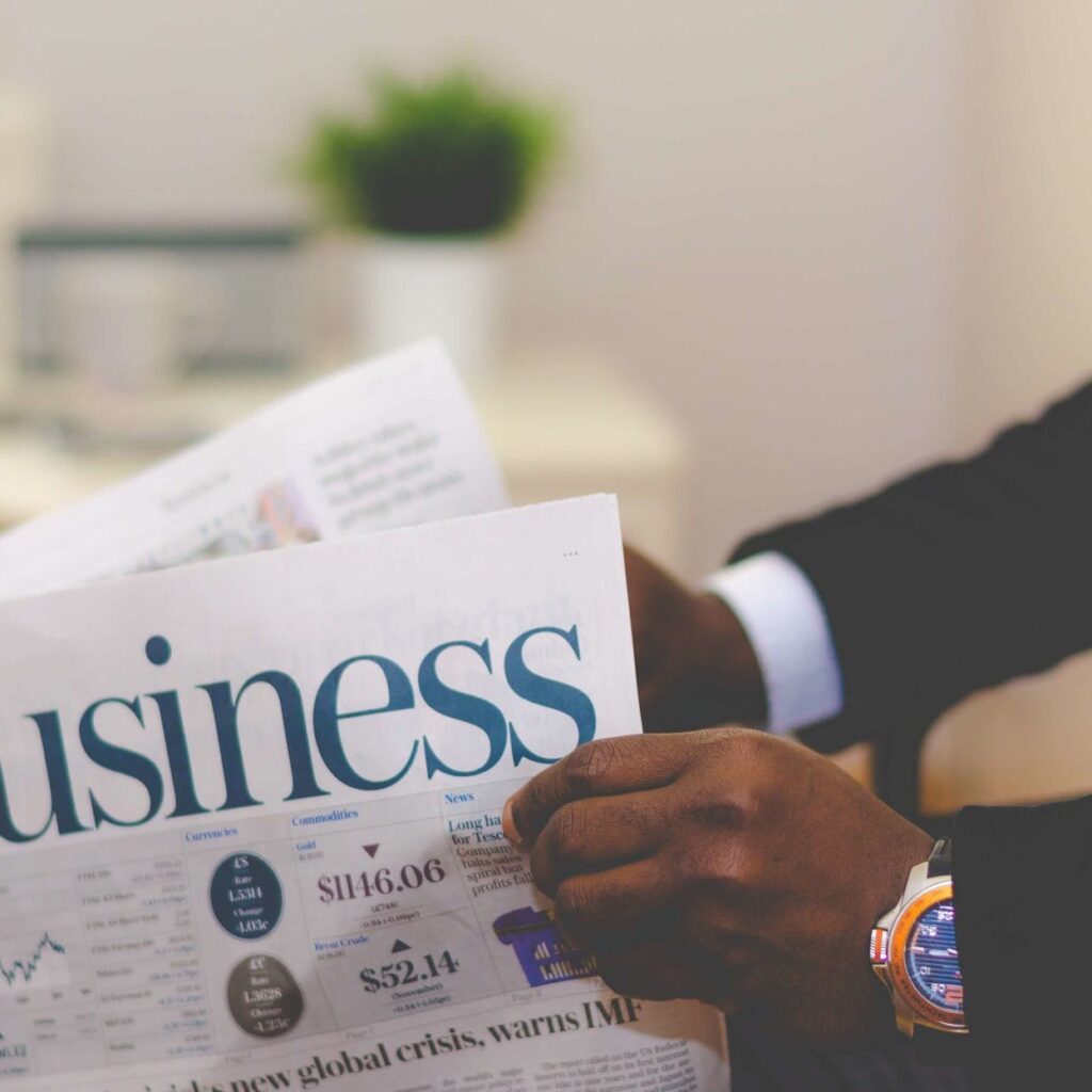 person holding white and blue business paper
