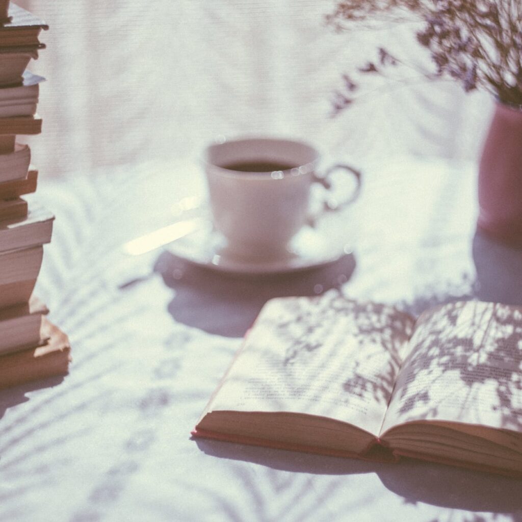 opened book near ceramic mug