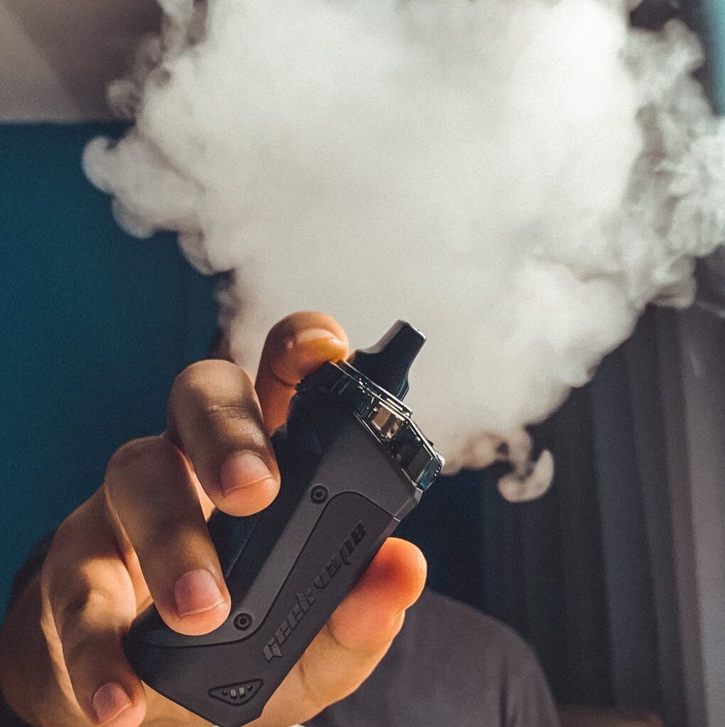 person holding black vape