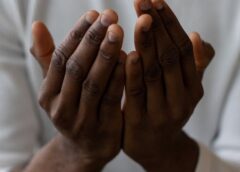 crop black man showing pray gesture