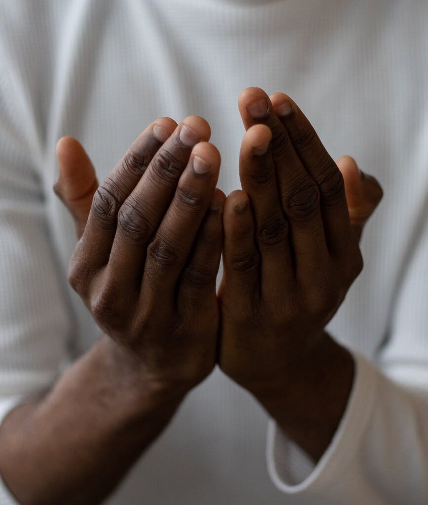 crop black man showing pray gesture