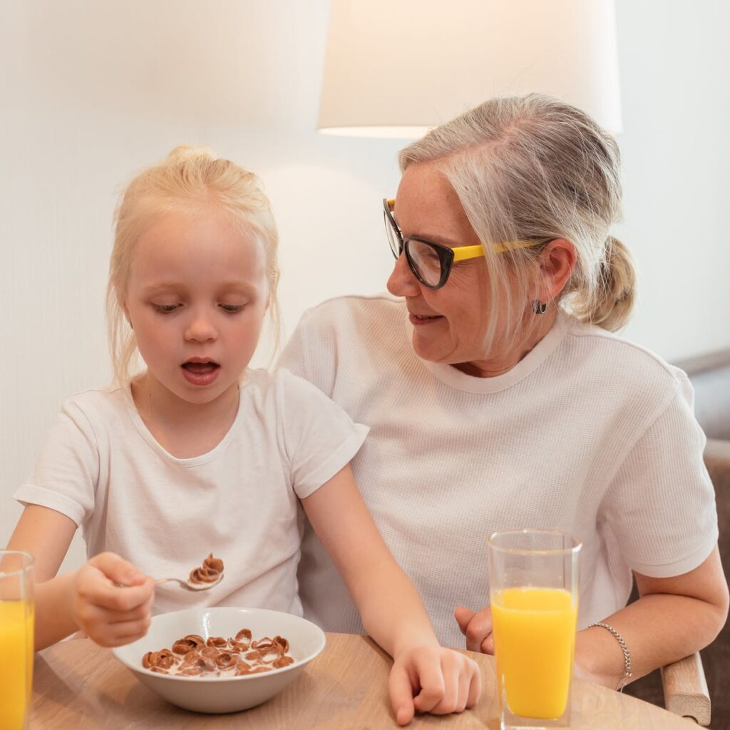 pensioner grandmother sitting with her granddaughter