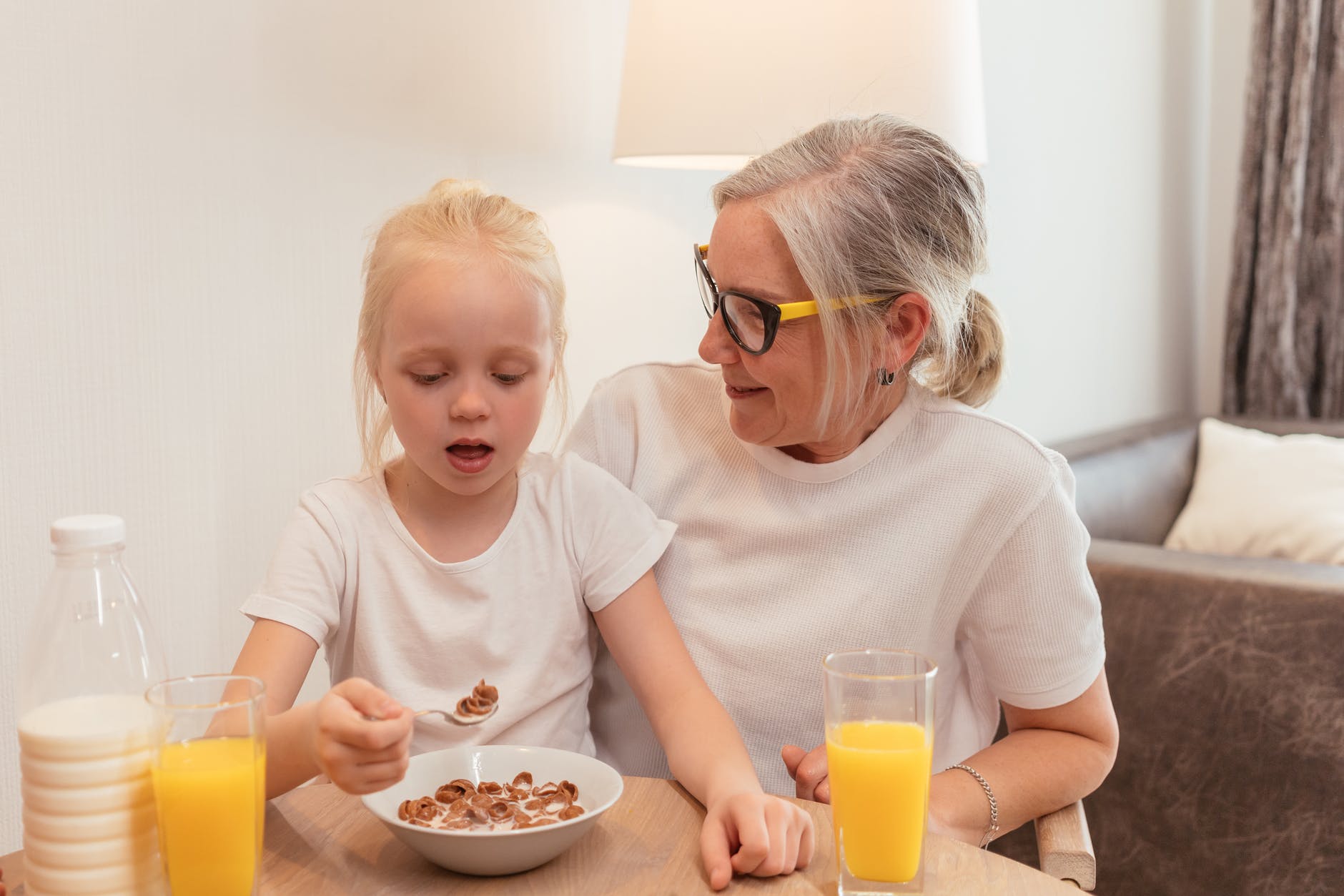 pensioner grandmother sitting with her granddaughter
