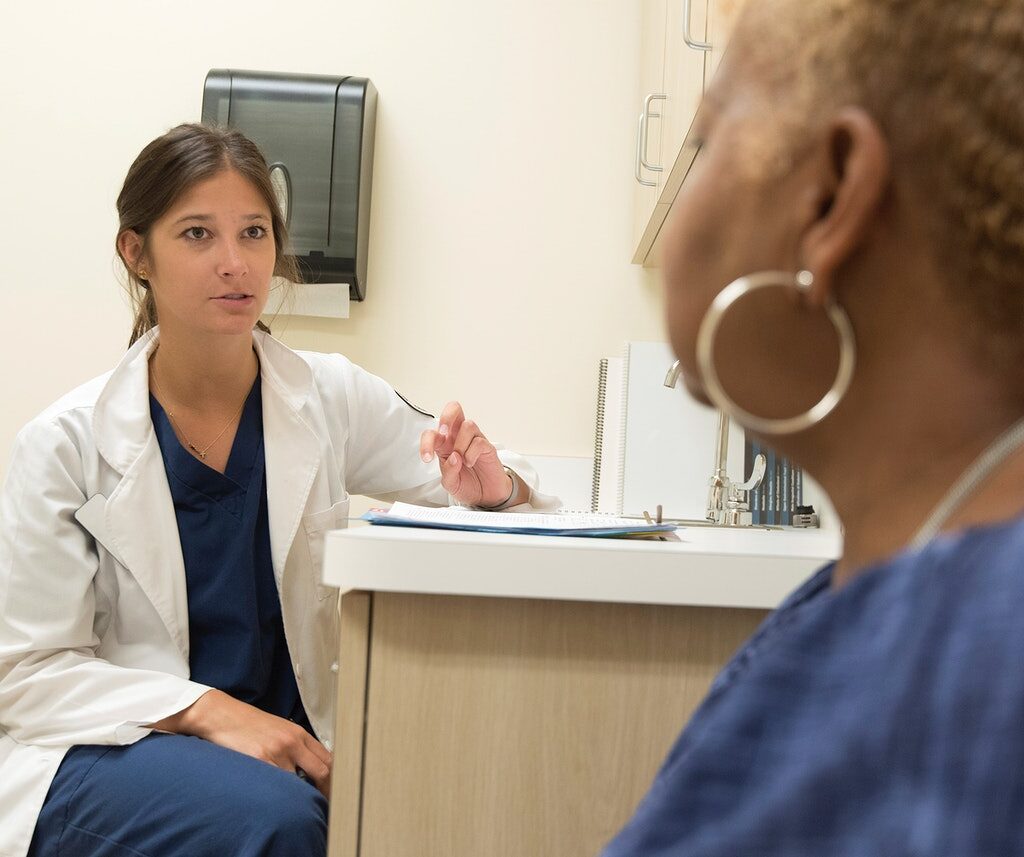 A doctor providing consult for a patient. Original image sourced from US Government department: Public Health Image Library, Centers for Disease Control and Prevention. Under US law this image is copyright free, please credit the government department whenever you can”.