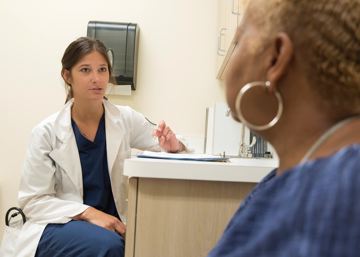 A doctor providing consult for a patient. Original image sourced from US Government department: Public Health Image Library, Centers for Disease Control and Prevention. Under US law this image is copyright free, please credit the government department whenever you can”.