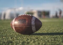 selective focus close up photo of brown wilson pigskin football on green grass