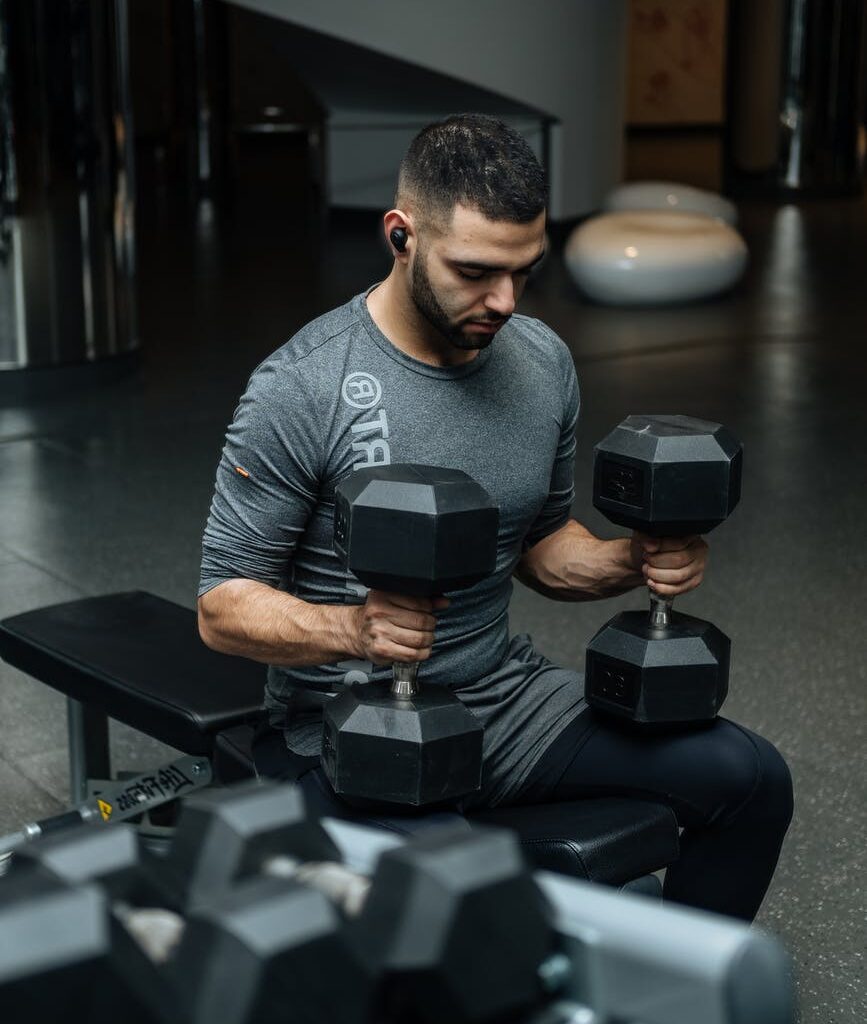 man sitting on flat bench