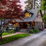 brown and white wooden house near green trees