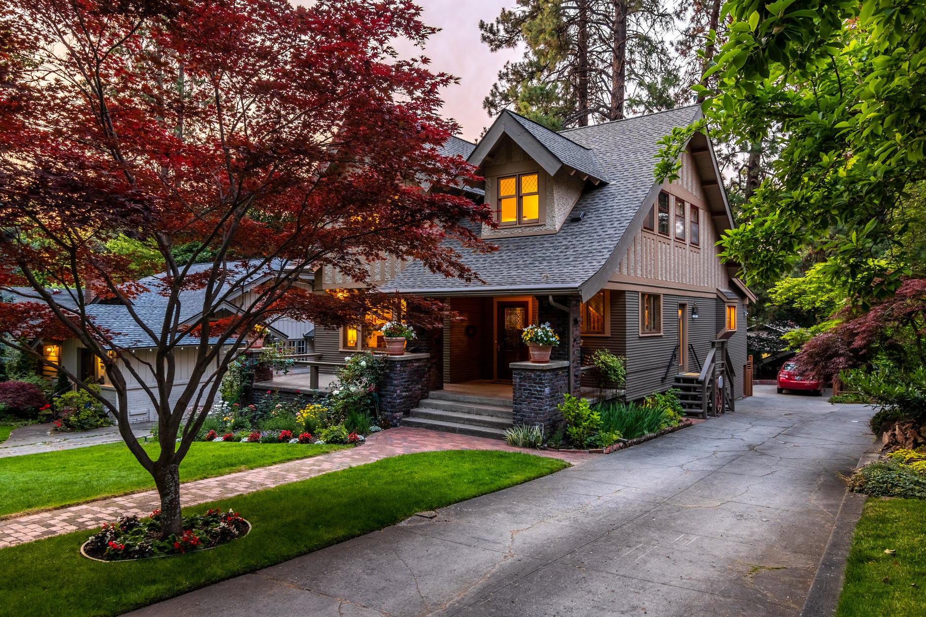 brown and white wooden house near green trees