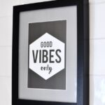 framed picture with inspirational text hanging on wall