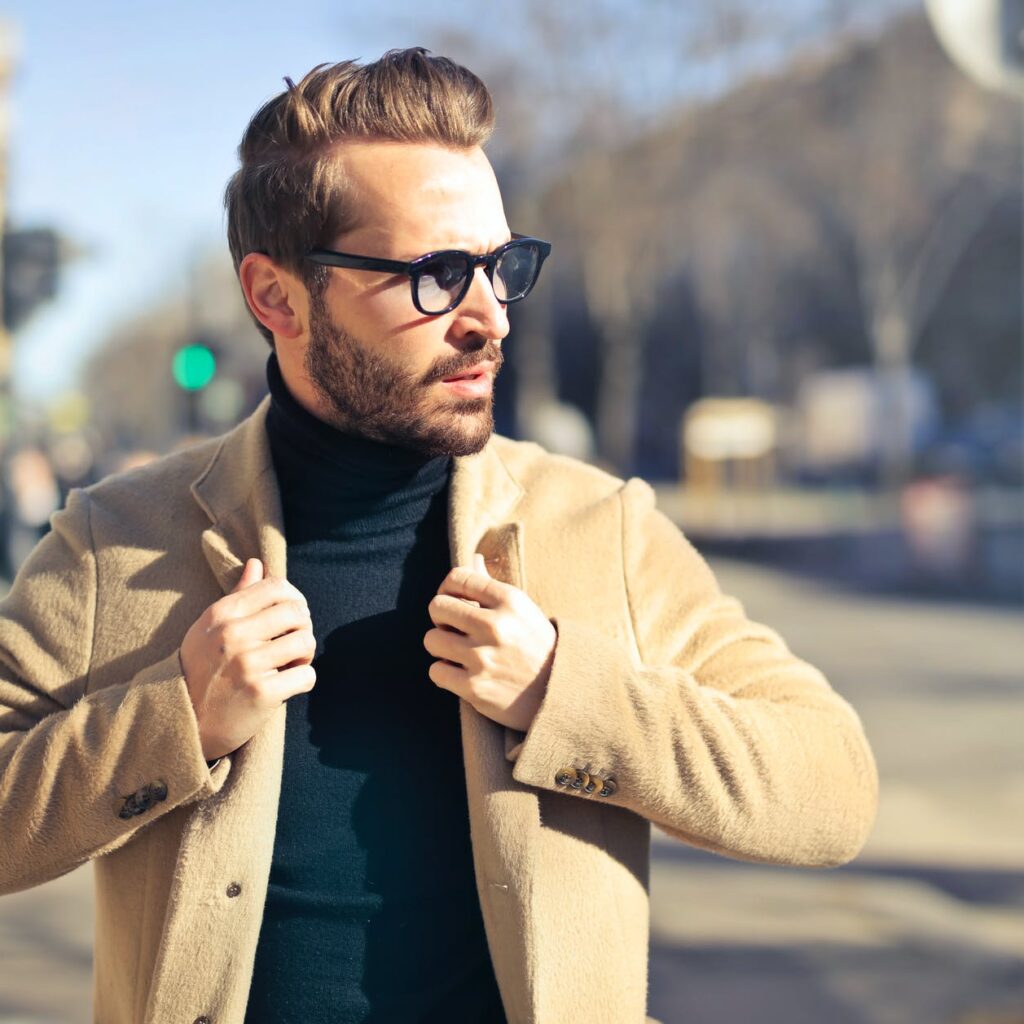 man wearing eyeglasses and brown jacket