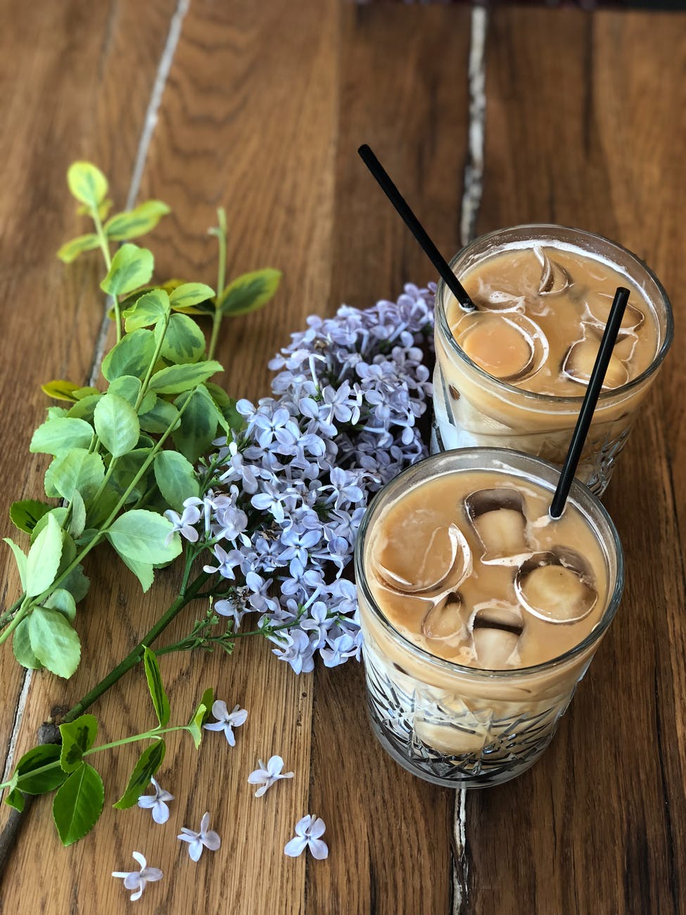 two brown liquid on glass with ice