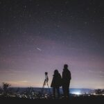 silhouette of two persons stargazing