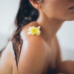woman with white flower on her shoulder