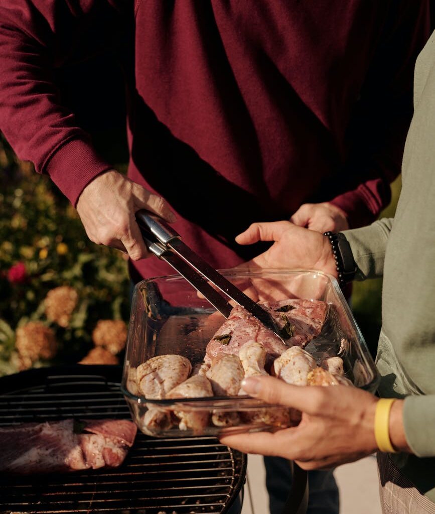 close up shot of a person grilling chicken