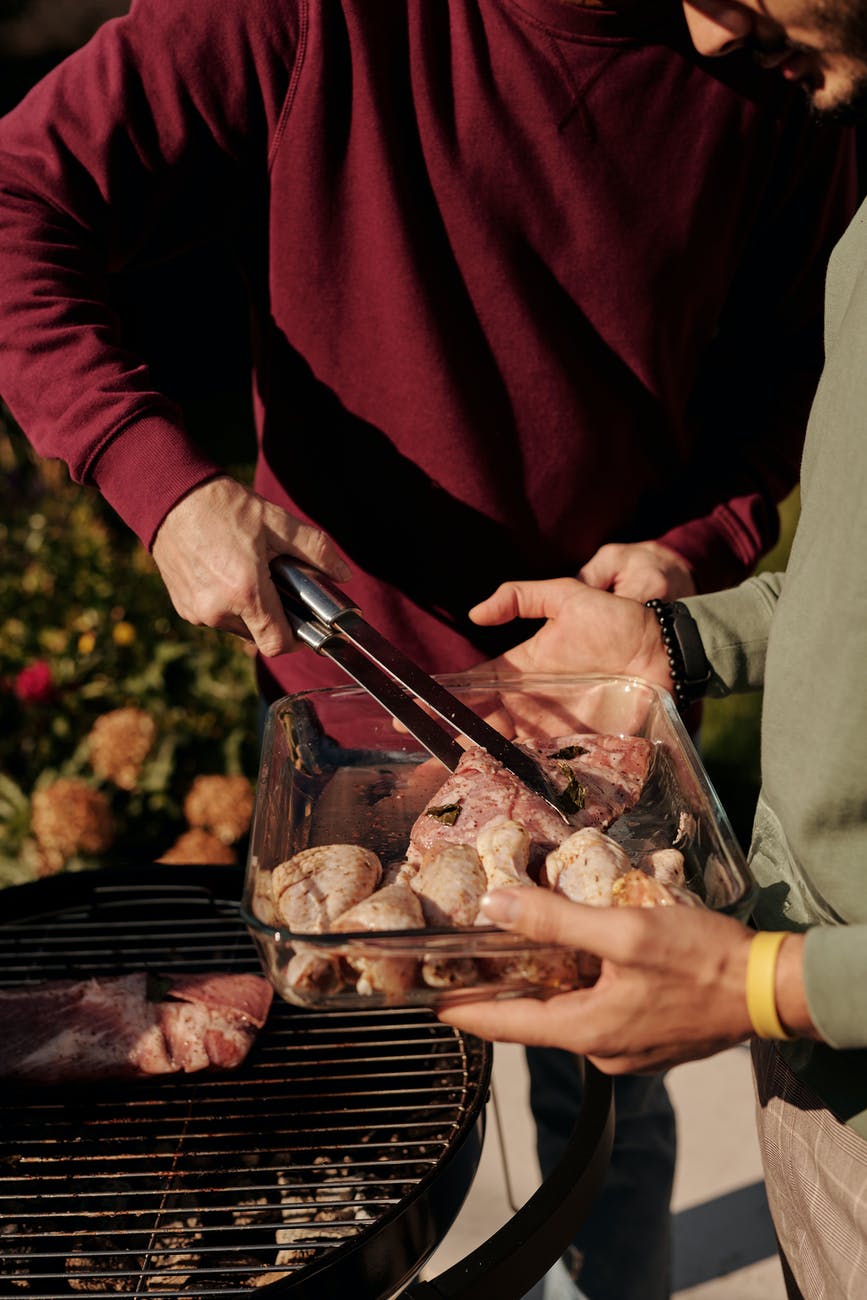close up shot of a person grilling chicken