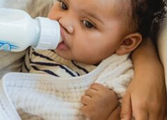 cute little baby drinking milk from bottle