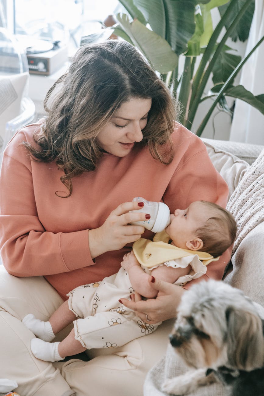 a mother feeding her baby