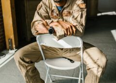 photo of soldier sitting on a folding chair