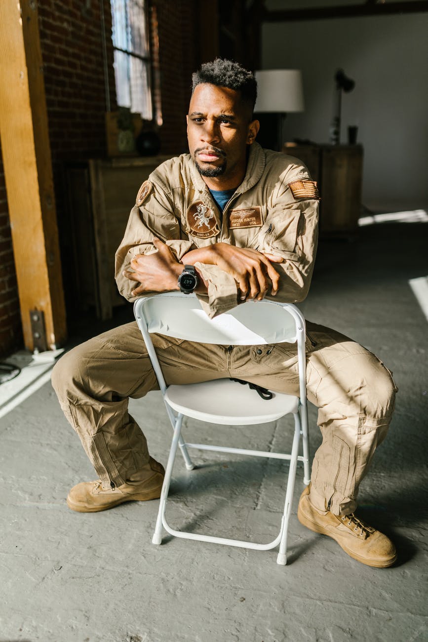 photo of soldier sitting on a folding chair