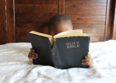 photo of child reading holy bible