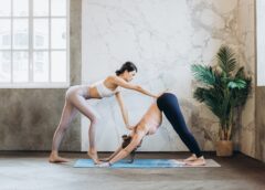 yoga instructor helping a student