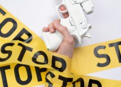 person holding yellow and white labeled paper