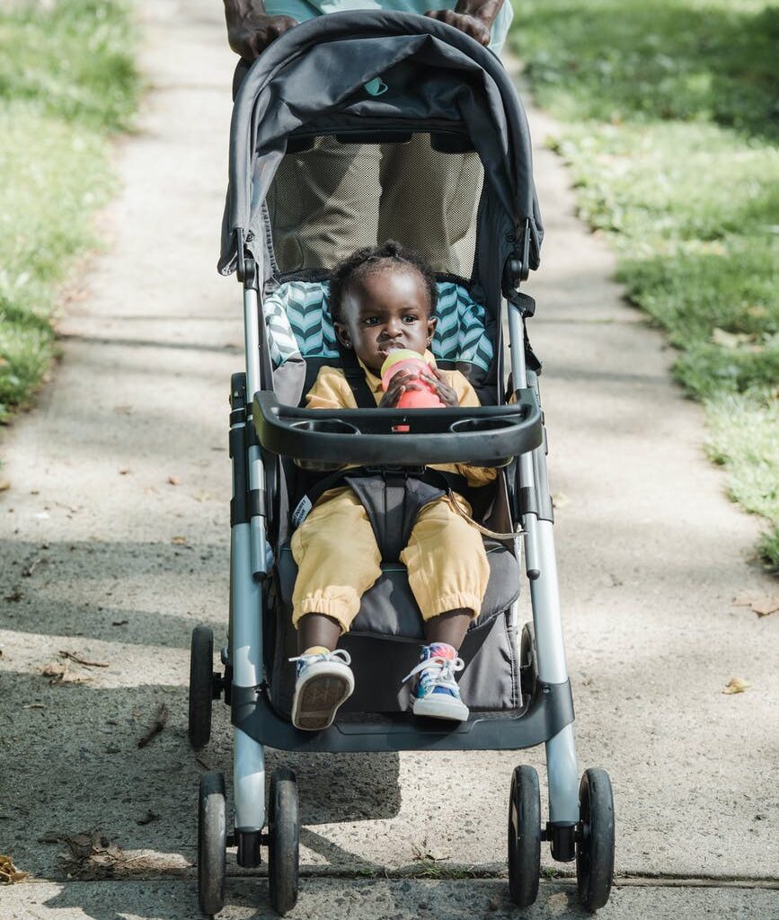 a baby in stroller on the street
