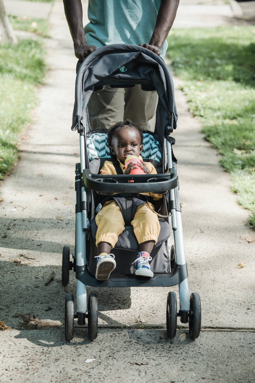 a baby in stroller on the street