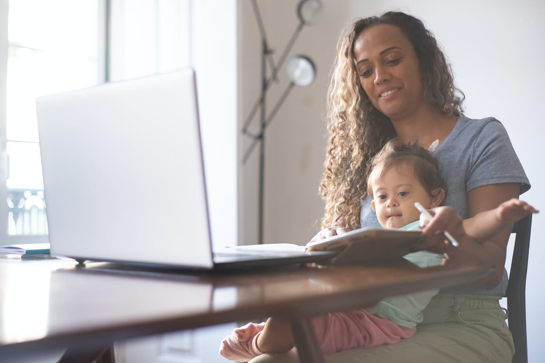 a mother taking care of her daughter while working