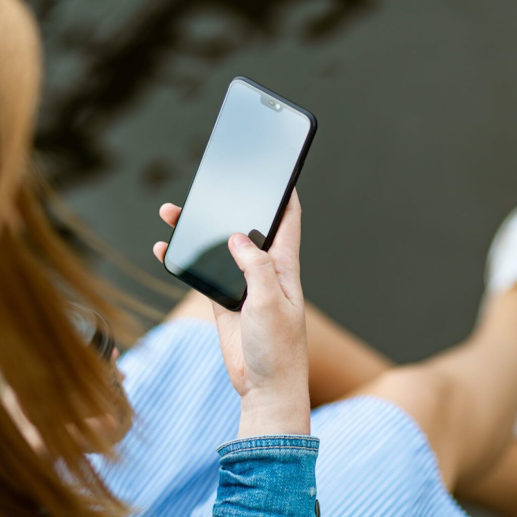 person holding smartphone white sitting