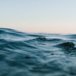 body of water under blue and white skies