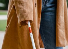 person holding a white cane