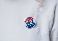 vote pin on a white sweater